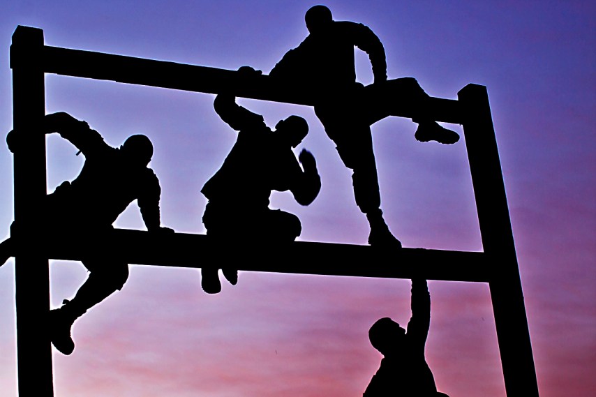 As the sun rises, Soldiers from Company F, 3rd Battalion, 227th Aviation Regiment, 1st Air Cavalry Brigade, 1st Cavalry Division, U.S. DivisionCenter, make their way through an obstacle course March 23. The second of eight events, the Soldiers were required to work together in order to complete all of the challenges.